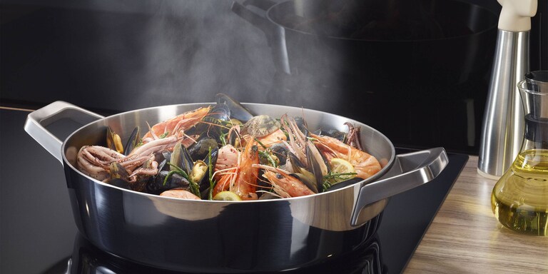 Steam from a pot rising to a cooker hood