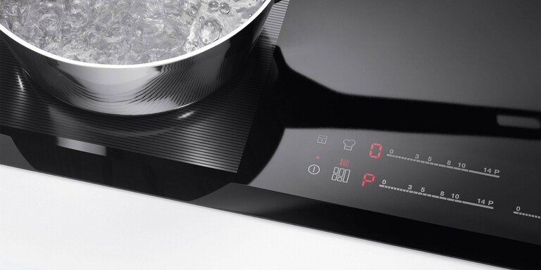 The stop and go button on an Electrolux induction hob